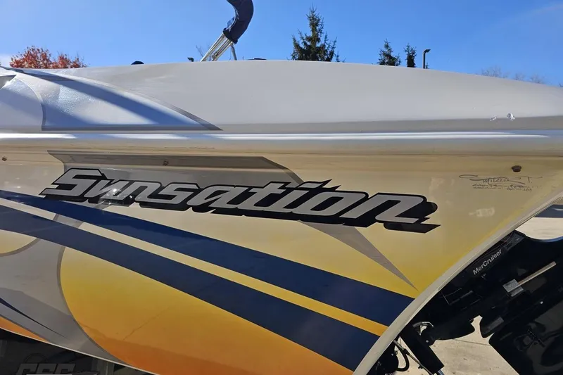 Slide: The Image of 2010 Sunsation 288 MID-CABIN - OPEN BOW boat with vibrant graphics and logo. - 29