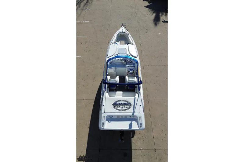Slide: The Image of 2010 Sunsation 288 MID-CABIN OPEN BOW boat, aerial view, sleek design, white and blue accents. - 37