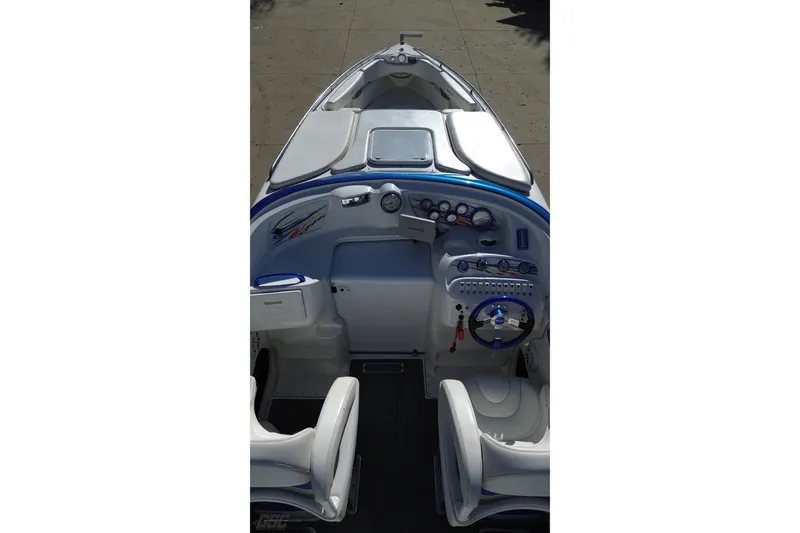 Slide: The Image of 2010 Sunsation 288 MID-CABIN OPEN BOW boat interior with steering wheel and dashboard controls. - 38