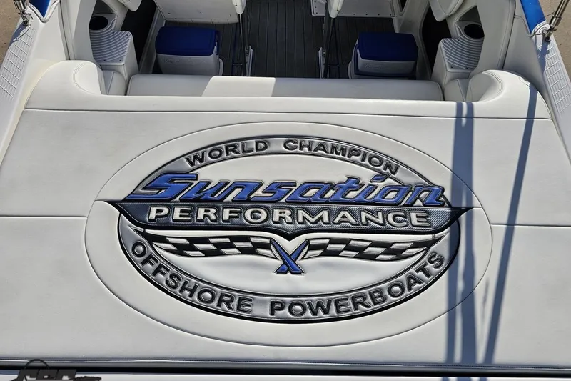 Slide: The Image of 2010 Sunsation 288 MID-CABIN boat interior with embroidered logo on white upholstery. - 47