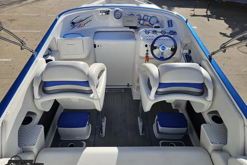 Slide: The Image of 2010 Sunsation 288 MID-CABIN boat interior with blue and white seating, modern dashboard. - 51