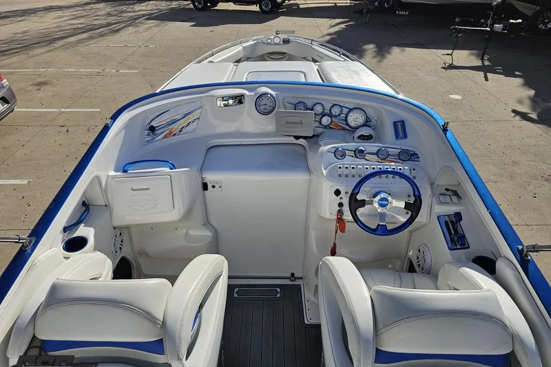 Slide: The Image of 2010 Sunsation 288 MID-CABIN boat interior with steering wheel and dashboard controls. - 52
