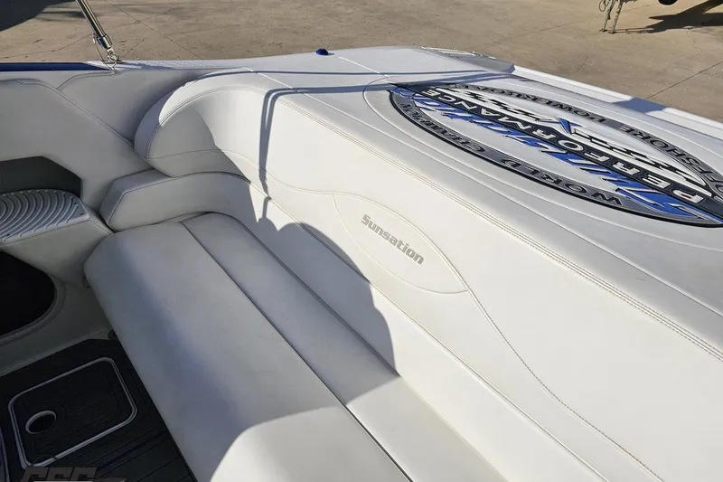 Slide: The Image of 2010 Sunsation 288 MID-CABIN boat interior with white leather seating and logo detailing. - 54