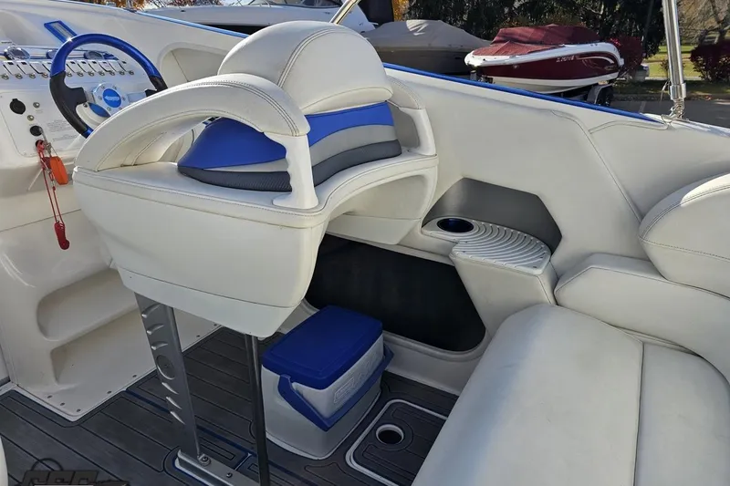 Slide: The Image of 2010 Sunsation 288 MID-CABIN boat interior with white seating and blue accents. - 55