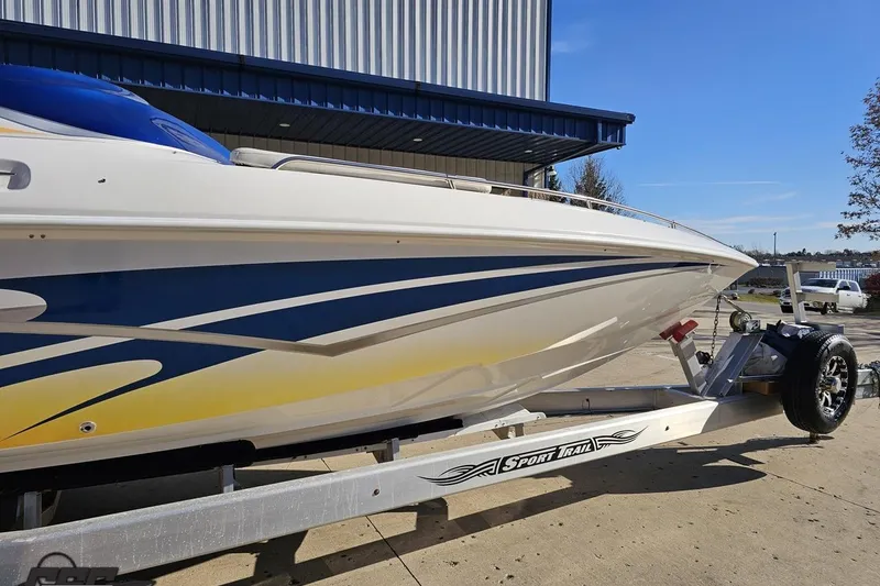 Slide: The Image of 2010 Sunsation 288 MID-CABIN - OPEN BOW boat on trailer, blue and yellow design. - 6