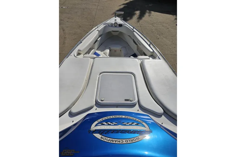 Slide: The Image of 2010 Sunsation 288 MID-CABIN OPEN BOW boat interior with white seating and blue accents. - 70