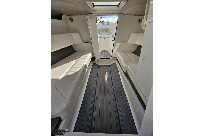 Slide: The Image of 2010 Sunsation 288 MID-CABIN interior with white seating and striped flooring. - 75