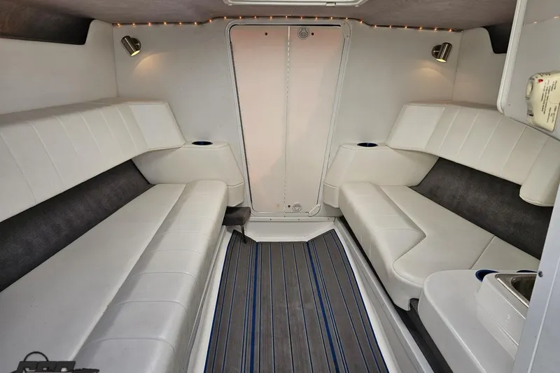 Slide: The Image of 2010 Sunsation 288 MID-CABIN interior with white seating and modern lighting. - 76