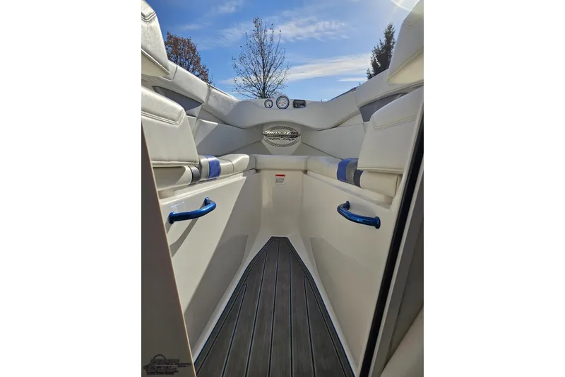 Slide: The Image of 2010 Sunsation 288 MID-CABIN boat interior with white seating and blue accents. - 87