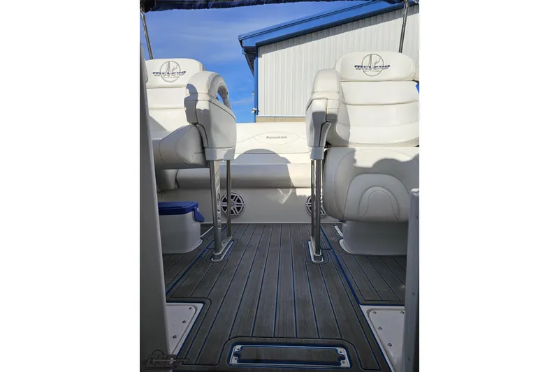 Slide: The Image of 2010 Sunsation 288 MID-CABIN boat interior with white seating and wood flooring. - 96
