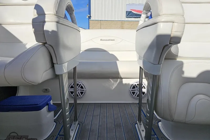 Slide: The Image of 2010 Sunsation 288 MID-CABIN interior with white seating and marine speakers. - 97