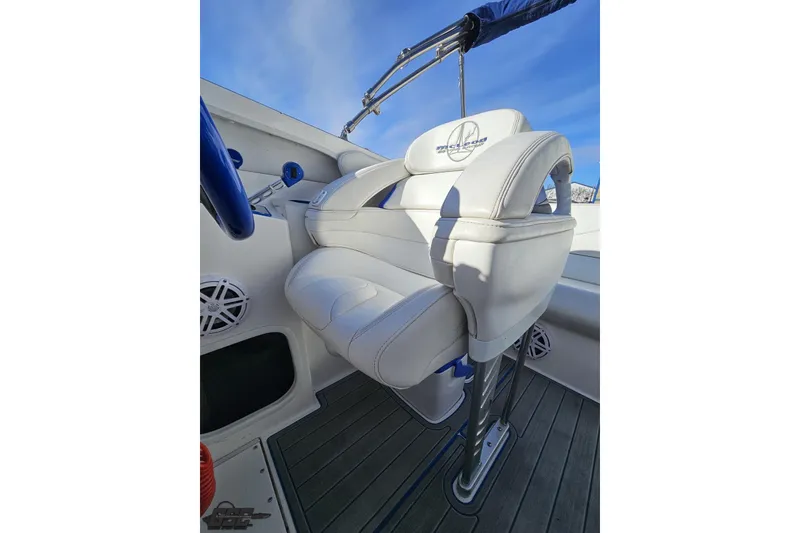 Slide: The Image of 2010 Sunsation 288 MID-CABIN boat interior with white leather seating and blue accents. - 99