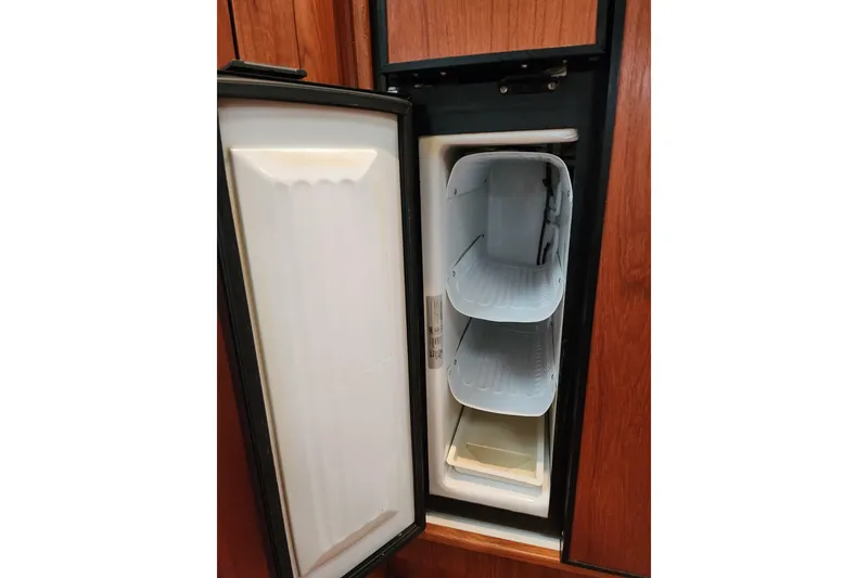 Slide: The Image of Open refrigerator in 2001 Tiara Yachts 3500 Open, showcasing interior shelves. - 19