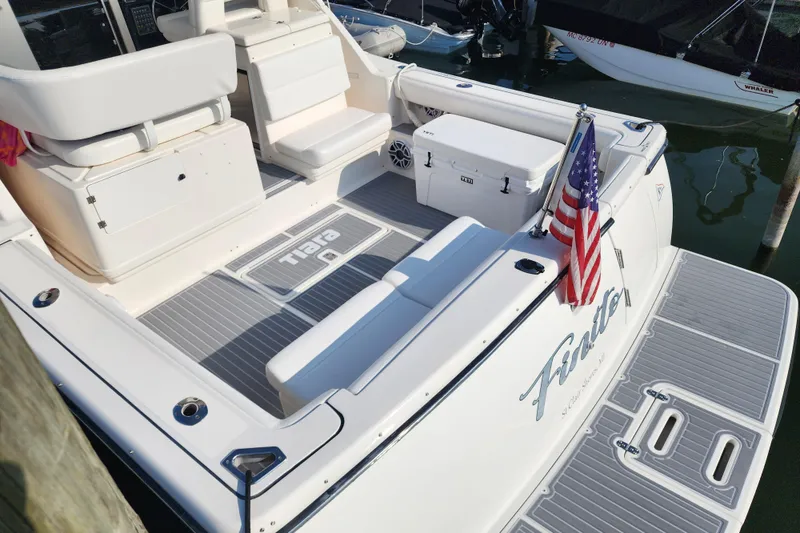 Slide: The Image of 2001 Tiara Yachts 3500 Open boat deck with seating and American flag. - 8