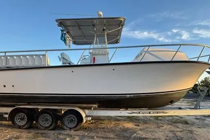 Slide: The Image of 2014 Newton 31 Dive Special boat on trailer under clear sky. - 12