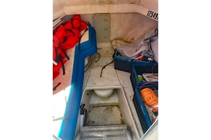Slide: The Image of Interior of a 2014 Newton 31 Dive Special boat with life jackets and storage. - 17