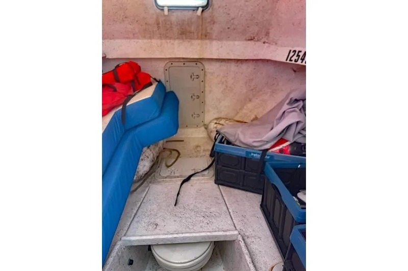 Slide: The Image of Interior of a 2014 Newton 31 Dive Special boat with seating and storage. - 18