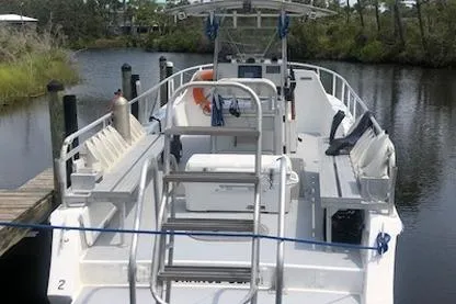Slide: The Image of 2014 Newton 31 Dive Special boat docked on a calm river. - 3