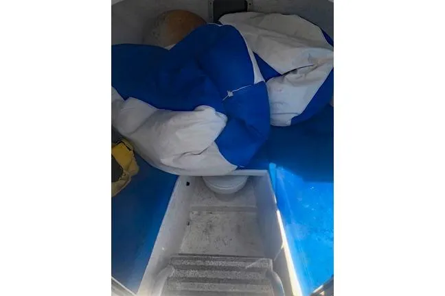 Slide: The Image of Interior of a 2014 Newton 31 Dive Special boat with blue and white seating. - 8