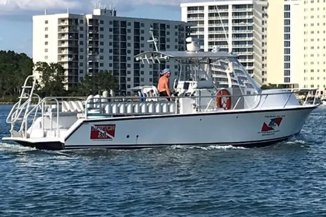 Slide: The Image of Newton 31 Dive Special boat cruising near waterfront buildings, 2014 model. - 9