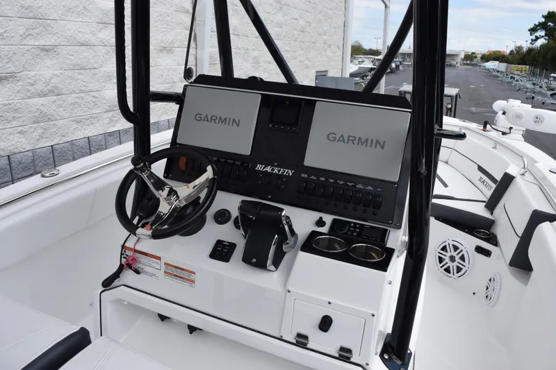 Slide: The Image of 2023 Blackfin 252 CC boat dashboard with Garmin displays and steering wheel. - 10