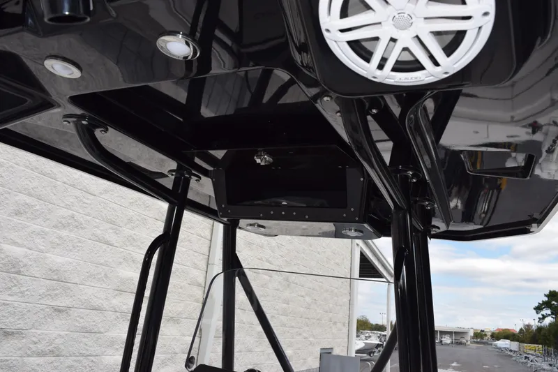 Slide: The Image of 2023 Blackfin 252 CC boat interior with sleek black design and modern speaker system. - 11