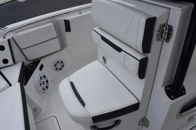 Slide: The Image of 2023 Blackfin 252 CC boat interior with white cushioned seating and speakers. - 14