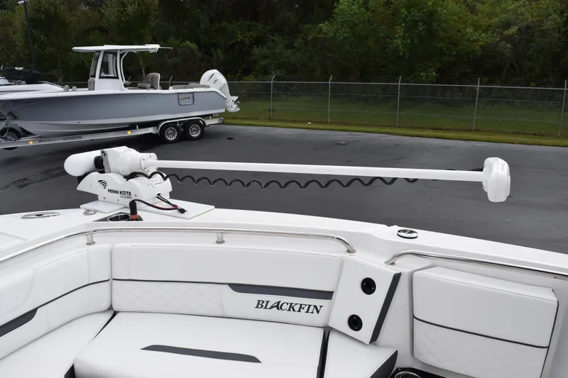 Slide: The Image of 2023 Blackfin 252 CC boat with Minn Kota trolling motor, parked on a trailer. - 15