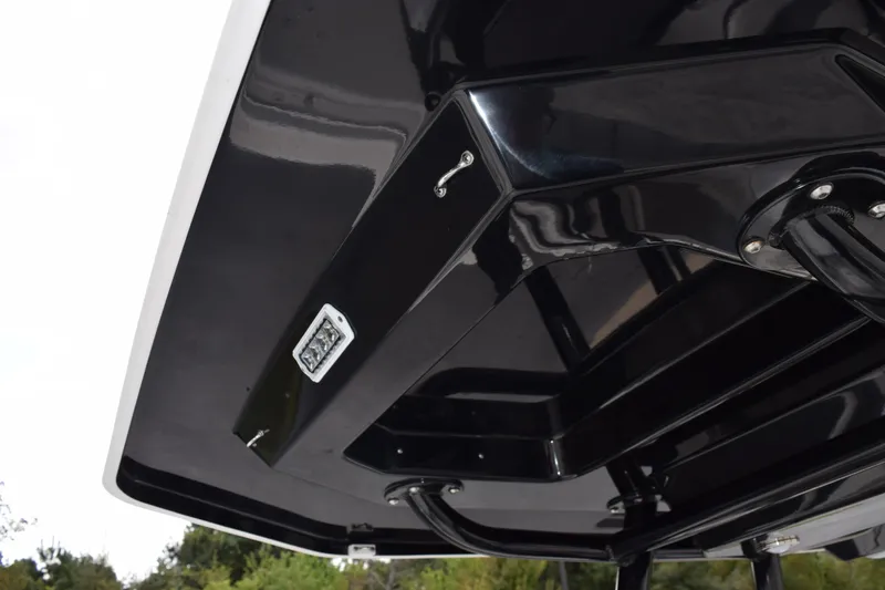 Slide: The Image of 2023 Blackfin 252 CC boat hull underside, showcasing sleek black design and hardware. - 16