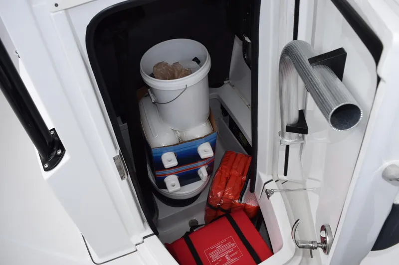 Slide: The Image of Storage compartment of 2023 Blackfin 252 CC boat with safety gear and supplies. - 18