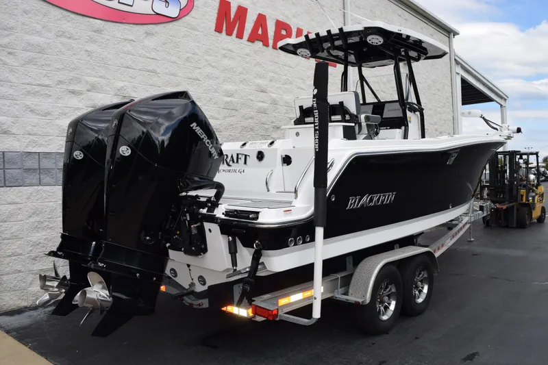 Slide: The Image of 2023 Blackfin 252 CC boat with dual Mercury engines on a trailer. - 4