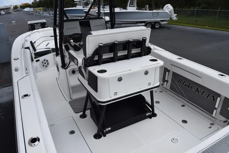 Slide: The Image of 2023 Blackfin 252 CC boat interior with seating and fishing rod holders. - 7
