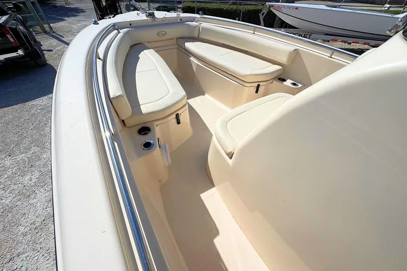 Slide: The Image of 2015 Grady-White Fisherman 257 boat interior with cushioned seating and cup holders. - 13