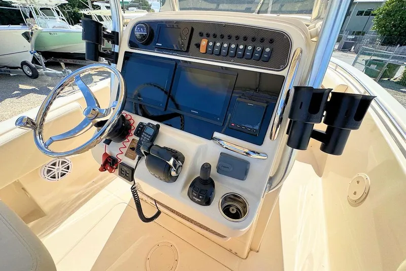 Slide: The Image of 2015 Grady-White Fisherman 257 boat console with steering wheel and navigation equipment. - 15