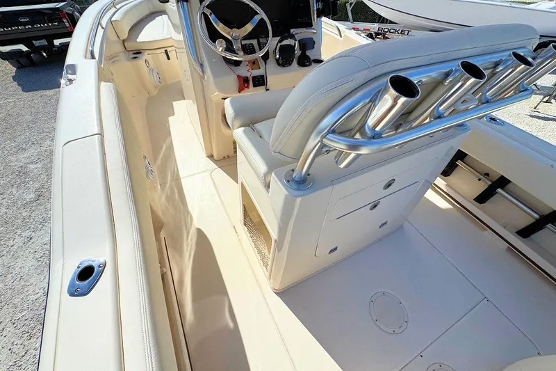 Slide: The Image of 2015 Grady-White Fisherman 257 boat interior with steering wheel and rod holders. - 9