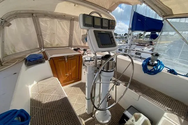 Slide: The Image of 1988 Morgan 44 yacht cockpit with steering wheel, navigation instruments, and seating area. - 13