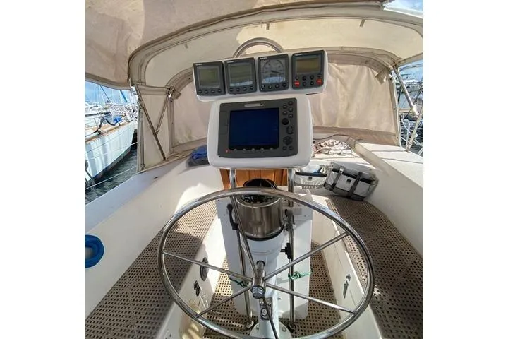 Slide: The Image of Cockpit of 1988 Morgan 44 sailboat with navigation instruments and steering wheel. - 14