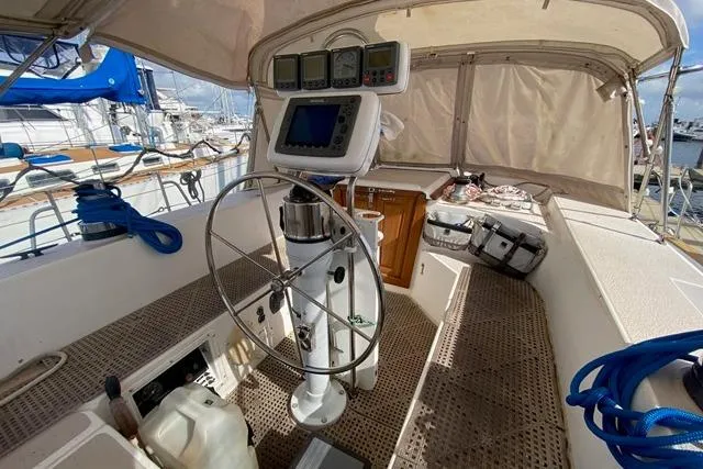 Slide: The Image of 1988 Morgan 44 sailboat cockpit with steering wheel, navigation instruments, and canopy. - 15