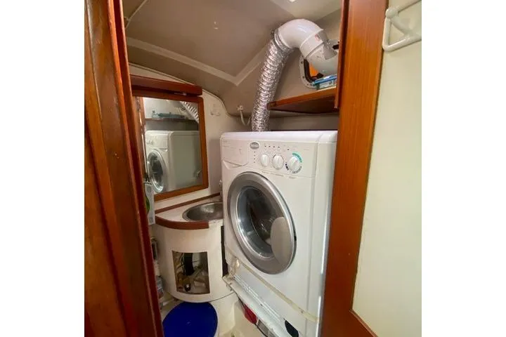 Slide: The Image of Laundry area inside 1988 Morgan 44 boat with washer and sink. - 21