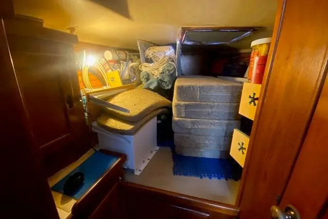 Slide: The Image of 1988 Morgan 44 yacht interior storage area with mattresses and supplies. - 22