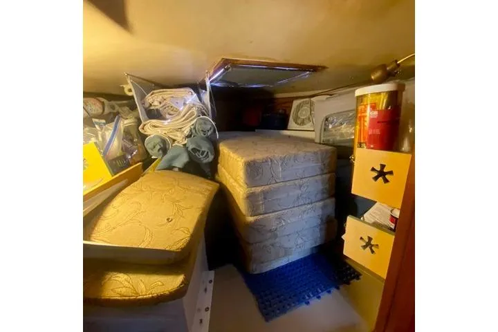 Slide: The Image of Interior storage space of a 1988 Morgan 44 boat, featuring cushions and supplies. - 23