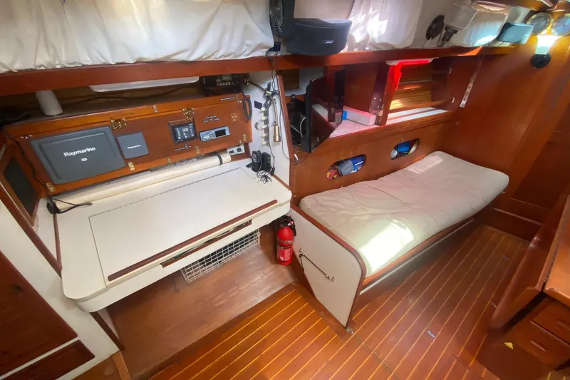 Slide: The Image of 1988 Morgan 44 yacht interior with navigation station and cozy sleeping area. - 25