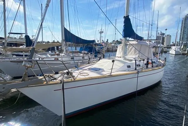 Slide: The Image of 1988 Morgan 44 sailboat docked in marina under clear blue sky. - 3