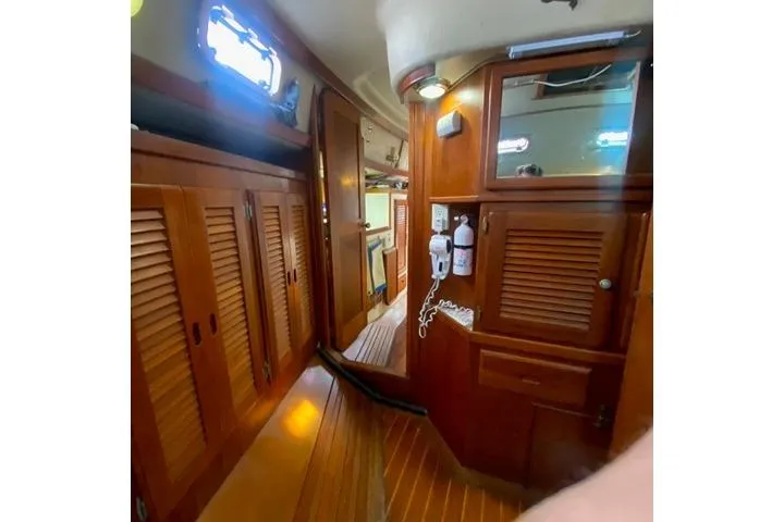 Slide: The Image of Interior of 1988 Morgan 44 sailboat with wooden cabinetry and nautical decor. - 33