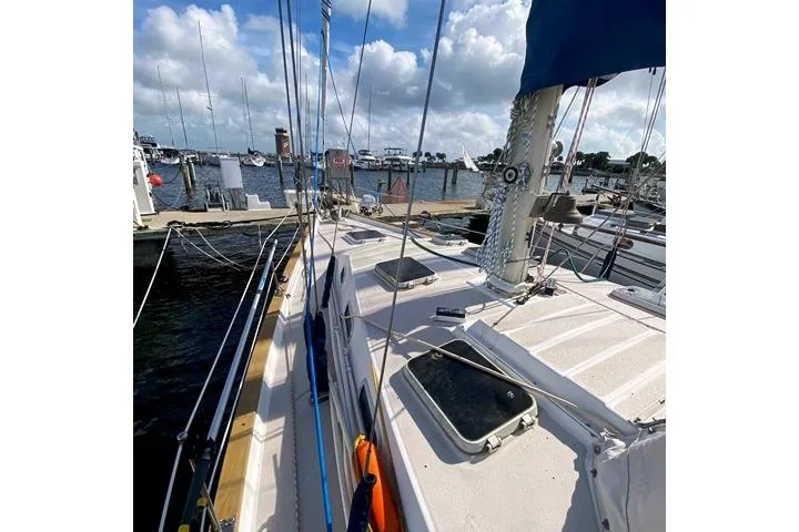 Slide: The Image of 1988 Morgan 44 sailboat docked at marina under cloudy sky. - 5