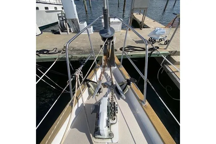 Slide: The Image of 1988 Morgan 44 sailboat bow with anchor and chain at dock. - 7