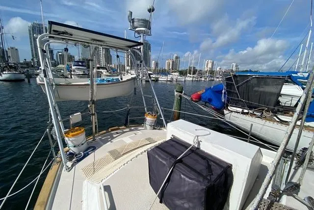 Slide: The Image of 1988 Morgan 44 sailboat docked in marina with city skyline in background. - 9