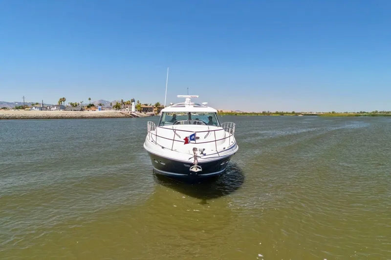 Slide: The Image of 2009 Sea Ray 470 Sundancer yacht cruising on a sunny day in calm waters. - 14