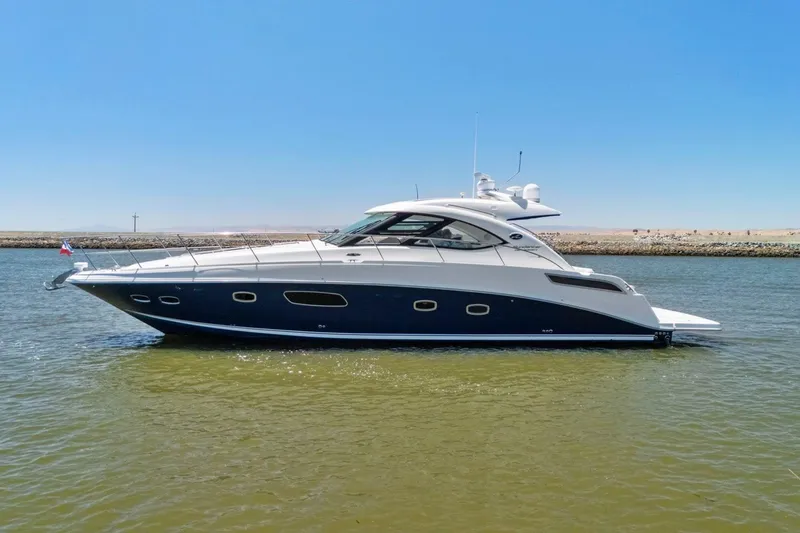 Slide: The Image of 2009 Sea Ray 470 Sundancer yacht on calm water under clear blue sky. - 16