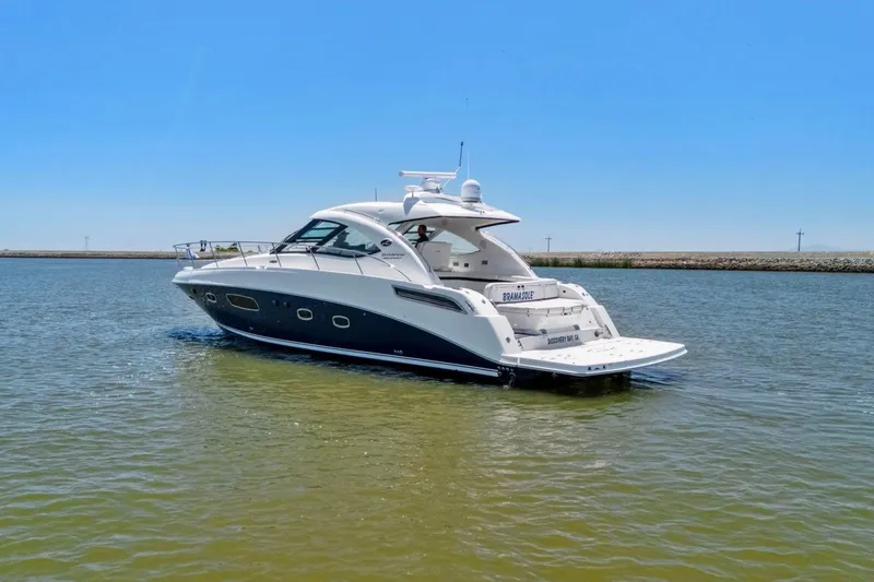 Slide: The Image of 2009 Sea Ray 470 Sundancer yacht cruising on calm waters under clear blue sky. - 17